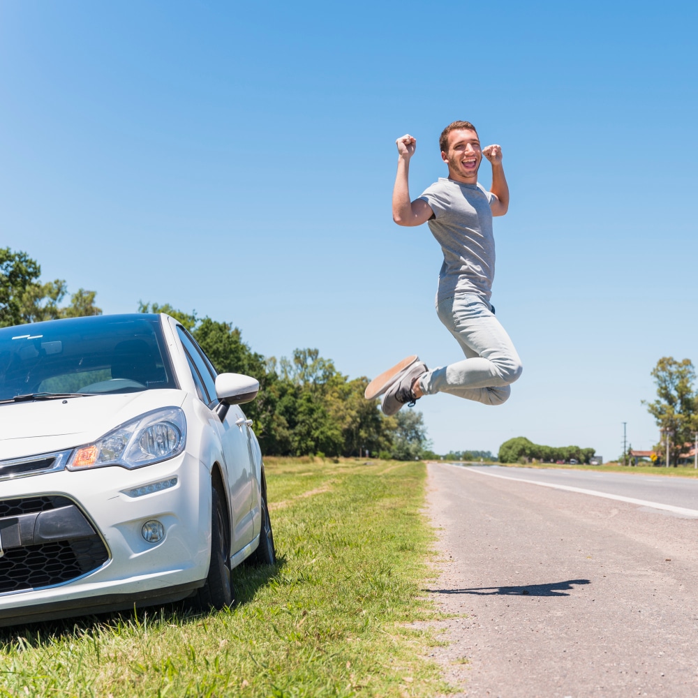 happy-boy-jumping-road-car